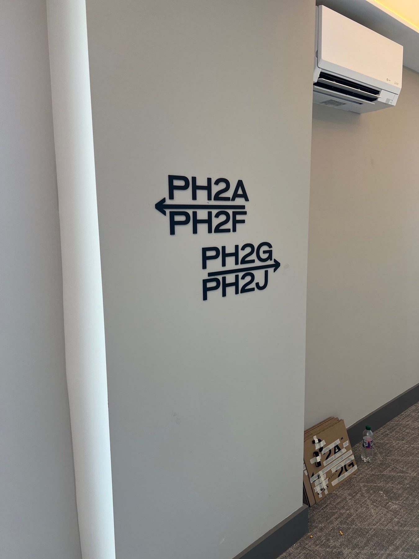 Directional wall lettering with apartment identifiers and arrows